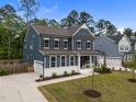 Inviting two-story home with a well-maintained lawn, attached garage, and a classic blue exterior at 3866 Keohane Dr, Durham, NC 27705