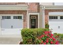Close-up of the front entrance with a black door and landscaped garden at 409 Summit Trail Dr, Hillsborough, NC 27278