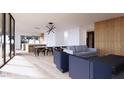 Open-concept living space with light wood floors, modern furniture, and kitchen view at 4120 Picardy Dr, Raleigh, NC 27612