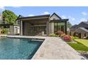 Beautiful backyard with a sparkling pool, covered patio, and putting green at 4139 Rockingham Dr, Raleigh, NC 27609