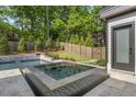 Inviting pool area with a tiled hot tub and privacy fence at 4139 Rockingham Dr, Raleigh, NC 27609