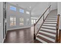 Bright living room boasts large windows, high ceilings, and elegant staircase at 450 Shale Creek Dr, Durham, NC 27703
