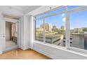 Bright room with a balcony offering city views from large windows and hardwood floors at 510 Glenwood Ave # 510, Raleigh, NC 27603