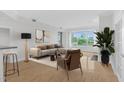 Bright living room featuring city views from large windows, modern furniture, and an accent plant at 510 Glenwood Ave # 510, Raleigh, NC 27603