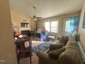 Cozy living room with a ceiling fan, fireplace, and a comfortable sofa, perfect for relaxation and gatherings at 5404 Drum Inlet Pl, Raleigh, NC 27610
