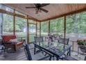 Relaxing screened porch with ceiling fan, string lights, and view of back yard at 5632 Falkirk Dr, Durham, NC 27712