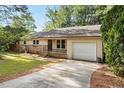 Traditional one-story house features a brick accent and a convenient attached garage at 5805 Farm Gate Rd, Raleigh, NC 27606