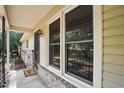 Welcoming front porch features a 'Welcome' mat, brick base, and view of the landscaped yard at 5805 Farm Gate Rd, Raleigh, NC 27606