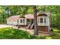 Attractive home with a lush green lawn and inviting entrance with stairs at 6204 Silver Spring Ct, Willow Springs, NC 27592