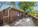 Spacious wooden deck with outdoor seating and beautiful wooden railing at 623 Oakgrove Dr, Graham, NC 27253