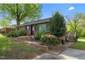 Inviting brick home with manicured landscaping, brick entry and stairs at 623 Oakgrove Dr, Graham, NC 27253