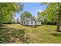 Beautifully landscaped yard with trees surrounding a well-maintained single-story home at 701 Oakwood St, Mebane, NC 27302