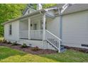 Inviting porch with white railings and landscaping, perfect for relaxing outdoors at 701 Oakwood St, Mebane, NC 27302