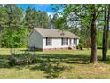Lovely home with well-manicured lawn, surrounded by trees, blending comfort with outdoor serenity at 7030 Shep Royster Rd, Oxford, NC 27565