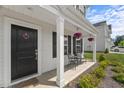 Inviting front porch features seating, decorative touches, and well-maintained landscaping at 80 Spotted Bee Way, Youngsville, NC 27596