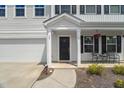 Inviting front porch with seating area, decorative accents, and a charming entrance at 80 Spotted Bee Way, Youngsville, NC 27596