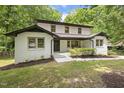 A picturesque view of the home's front facade and the surrounding lush greenery at 814 Ellynn Dr, Cary, NC 27511