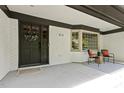 Inviting front porch with stylish seating, a decorative wreath, and brick accents at 814 Ellynn Dr, Cary, NC 27511