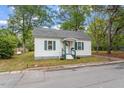 Exterior view of a cozy one-story home with green shutters and a well-manicured lawn at 820 Southern St, Selma, NC 27576