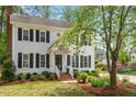 Charming two-story home with black shutters and inviting front entrance, complemented by lush landscaping at 8504 Boot Ct, Raleigh, NC 27615