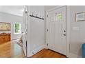 Bright entryway with hardwood floors, a coat rack and a view to the bedroom at 905 Carroll St, Durham, NC 27701