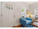 Cozy living room featuring a blue accent chair and hardwood flooring at 905 Carroll St, Durham, NC 27701