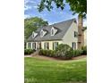 Beautiful two-story home with a classic design, dormer windows, and lush landscaping at 9301 Brookton Ct, Raleigh, NC 27615