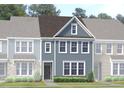Charming two-story townhome featuring classic design elements and a welcoming entrance at Lot 7 Cooper St, Sanford, NC 27330