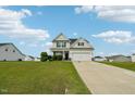 Charming two-story home with a well-manicured lawn and an extra long driveway at 105 Chandon Dr, Princeton, NC 27569
