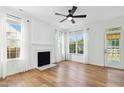 Bright living room features hardwood floors, white walls, and fireplace at 1121 Silky Dogwood Trl, Apex, NC 27502