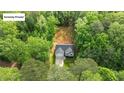Aerial view of home nestled in the woods, showcasing its unique location with mature trees at 118 Chanute Cir, Louisburg, NC 27549