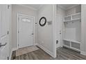 Welcoming entryway with wood flooring, a storage cubby and coat hooks, and a decorative front door at 118 Chanute Cir, Louisburg, NC 27549