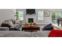 Cozy living room with a fireplace, neutral paint, and an open concept layout perfect for relaxation at 118 Chanute Cir, Louisburg, NC 27549