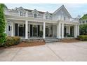 Two-story home featuring a balcony and a large covered porch at 118 Duncansby Ct, Cary, NC 27511