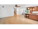 Bright living room with wood floors, adjacent kitchen and a staircase leading to upper level at 121 Ladybug Ln, Chapel Hill, NC 27516