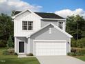 Charming two-story home with gray siding, a two-car garage, manicured lawn, and mature trees at 1215 Pond Overlook Drive, Nashville, NC 27856