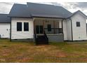 Gorgeous back porch featuring a black railing and steps leading into the yard at 123-125 Ottawa Dr., Louisburg, NC 27549