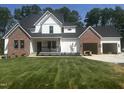Beautiful new construction home with a combination of white siding and brick exterior, plus an attached two car garage at 123-125 Ottawa Dr., Louisburg, NC 27549