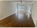 Bright living room featuring wood floors, a ceiling fan, and natural light at 1321 Crab Orchard Drive # 203, Raleigh, NC 27606