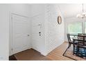 Bright foyer with white brick accent wall, and view into the dining area at 1504 Oak Tree Dr, Chapel Hill, NC 27517