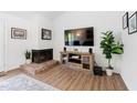 Cozy living room with brick fireplace, mounted television, and decorative accents at 1504 Oak Tree Dr, Chapel Hill, NC 27517