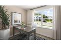Bright home office features a large window, neutral walls, and stylish decor for a productive workspace at 172 Holmes Corner Dr, Smithfield, NC 27577