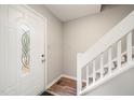 Inviting entryway featuring a decorative glass door, wood floors, and a staircase with white railings at 1903 Malone Rd # E, Burlington, NC 27215