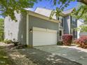 Exterior showcasing a well-maintained home with a two-car garage and lush landscaping at 1911 Housatonic Ct, Apex, NC 27523