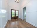 Bright and airy foyer with hardwood floors and stylish wainscoting at 2 Deer Run Trl, Hillsborough, NC 27278