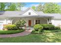 Charming single-Gathering home featuring a manicured lawn and mature landscaping at 2008 Elizabeth Ct, Clayton, NC 27520