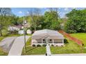 Exterior of a cozy home with a metal roof, landscaped yard, and inviting front porch at 212 Orange St, Oxford, NC 27565