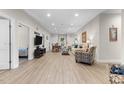Bright living room with wood floors, modern furnishings, and access to the dining area at 212 Orange St, Oxford, NC 27565