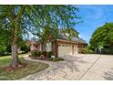Spacious three-car garage with well-maintained driveway and beautiful landscaping around the home at 220 Lakecroft Pl, Fuquay Varina, NC 27526