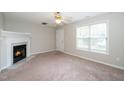 Bright living room with fireplace and large window bringing in natural light at 2253 Violet Bluff Ct, Raleigh, NC 27610